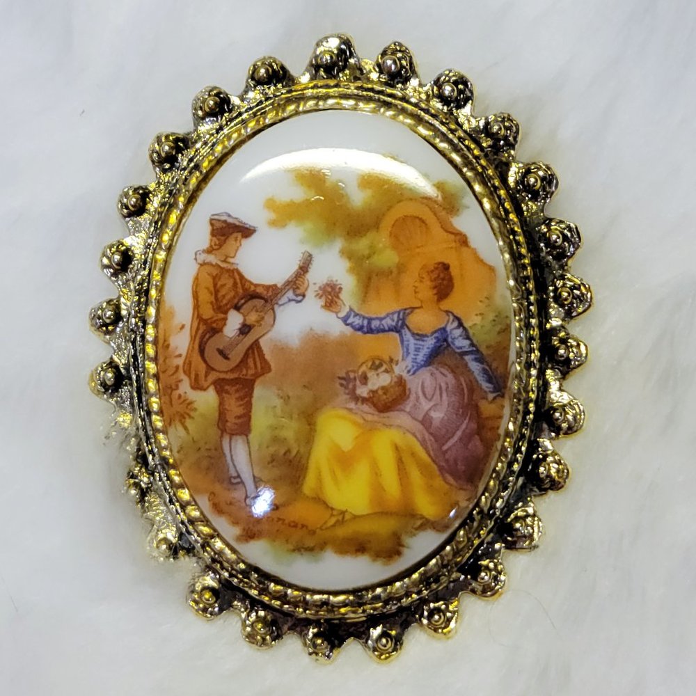 Vintage ceramic courting couple with a gold toned setting
